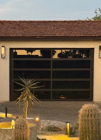 Full-view black glass garage door installation at Paradise Valley, AZ home