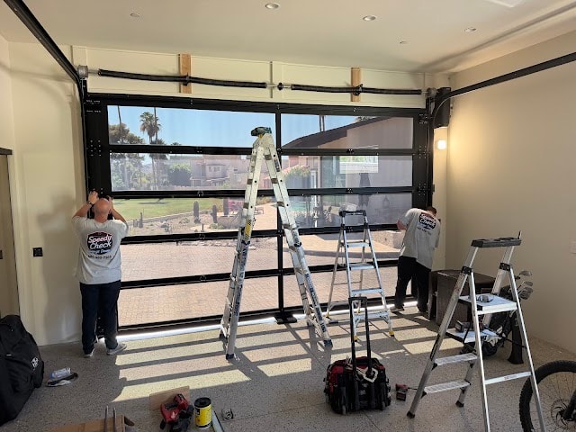 Speedy Check team installing full-view glass garage door in Paradise Valley, AZ
