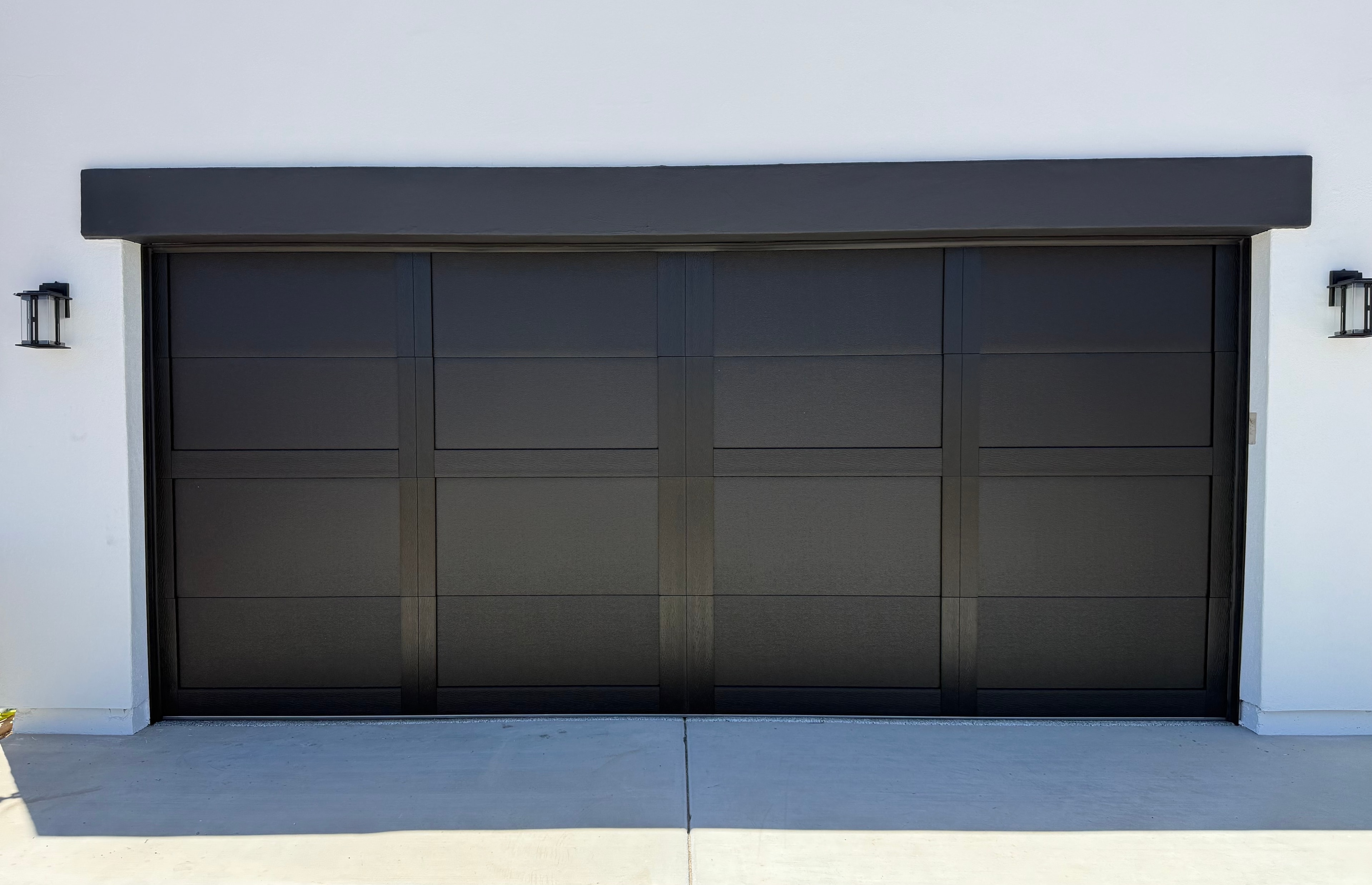 Modern charcoal flush-panel garage door new installation in Wittman, AZ